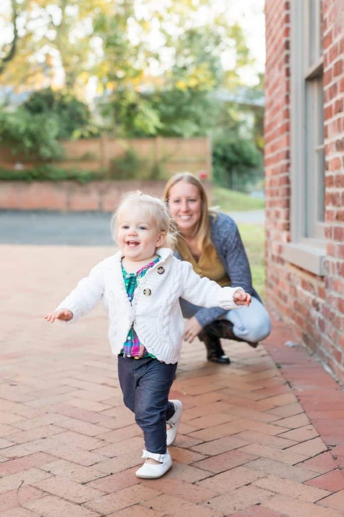 Toddler smiling and running away from mom 