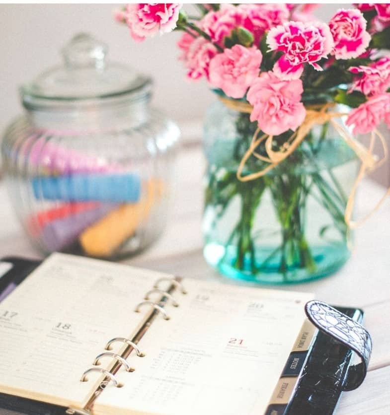 schedule on table with flowers