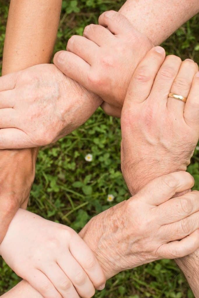 People holding wrists for support group