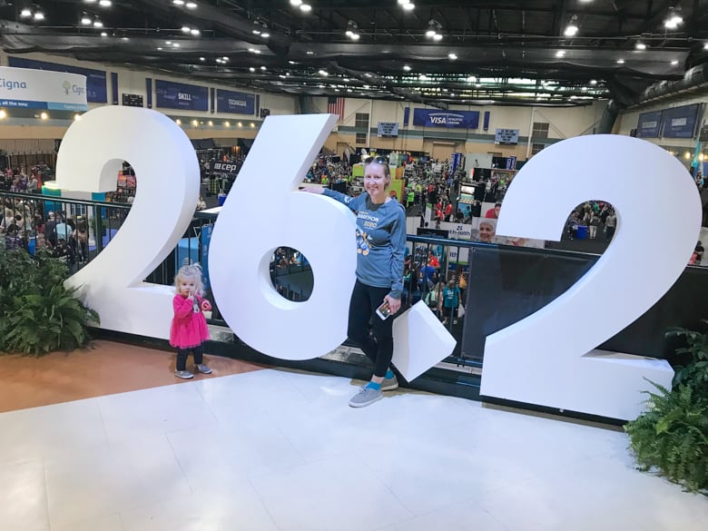Girl in front of 26.2 sign at Disney Marathon Expo