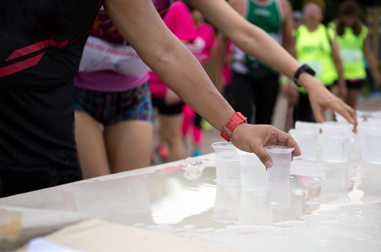 handing out water cups at marathon