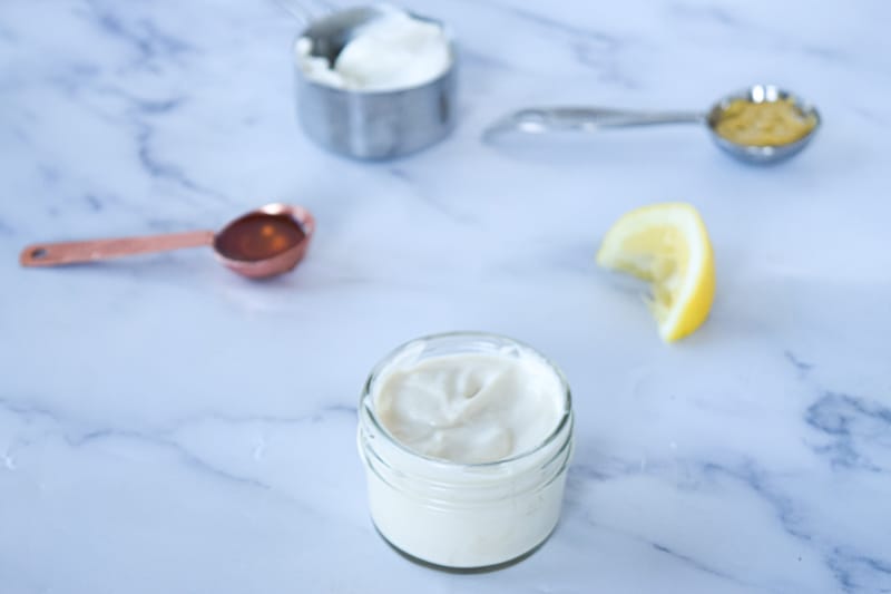 Honey Greek Yogurt dressing with honey, lemon, greek yogurt and dijon mustard on countertop 