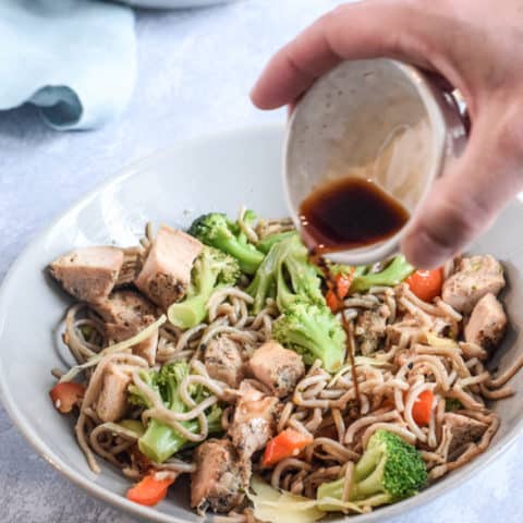 Pouring soy sauce over Stir fry egg noodles with chicken | Bucket List Tummy