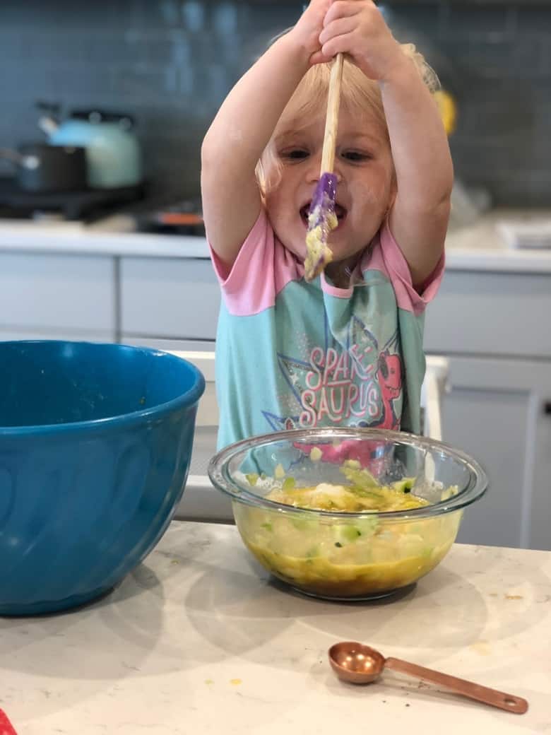 toddler helping in kitchen