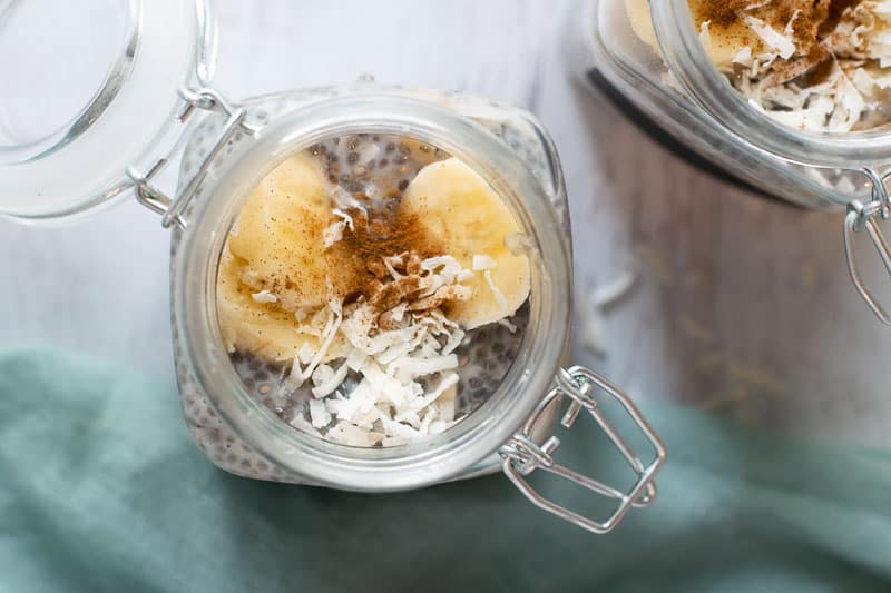 Banana chia pudding topped with banana slices and coconut flakes in mason jar