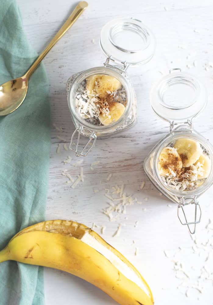 clear mason jar with top open with chia pudding and banana slices