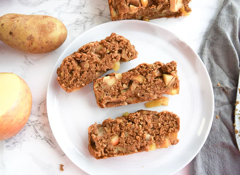 Healthy apple bread cut into slices on white plate