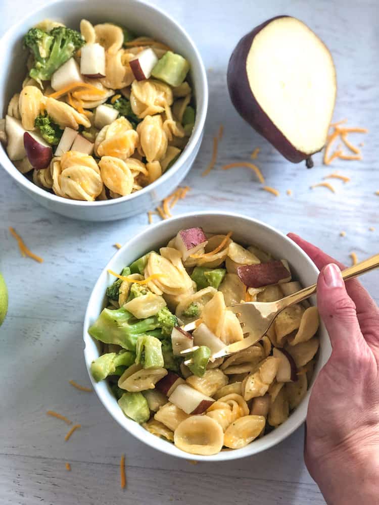 two white bowls with homemade toddler mac and cheese with pears and broccoli