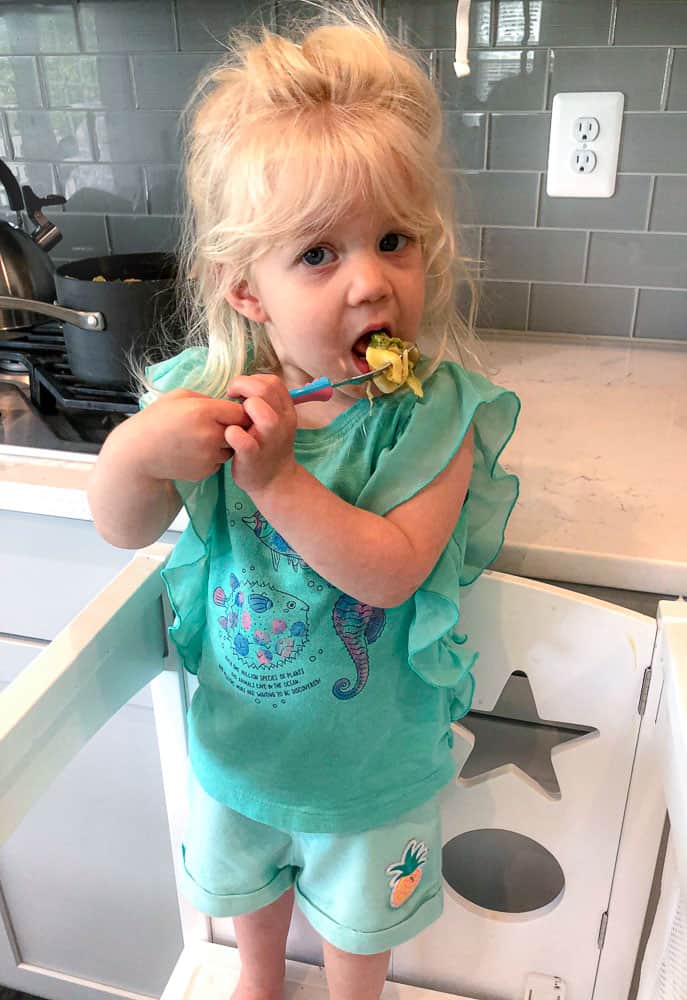 toddler eating a mac and cheese