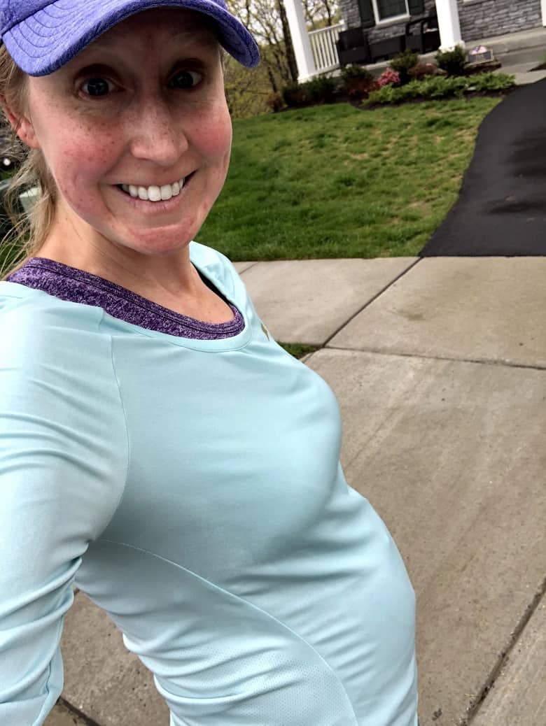 girl after running while pregnant with purple hat