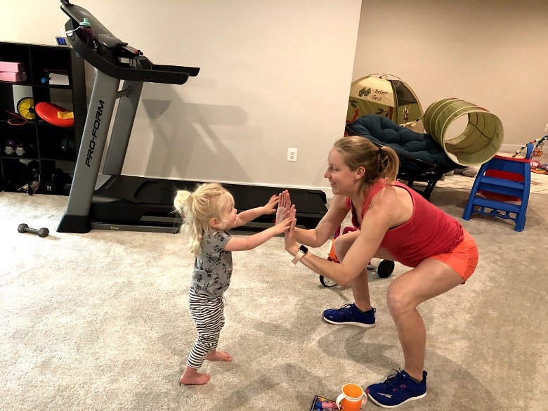 mom and daughter high fiving during workout