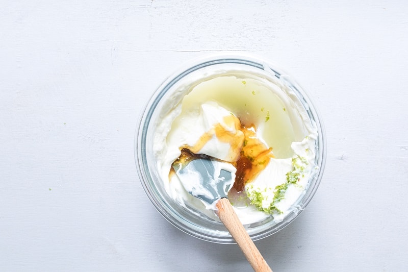greek yogurt and honey mixed in clear tupperware