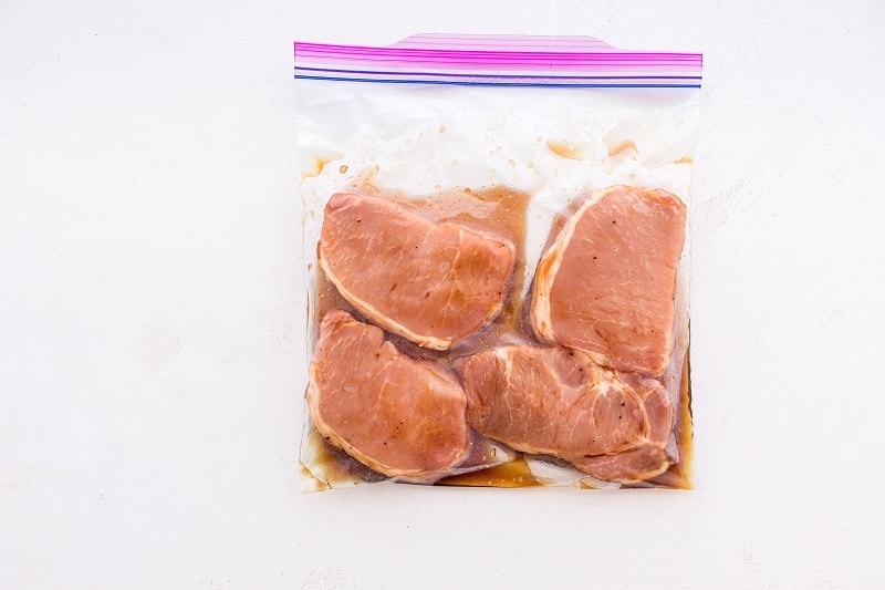 ziplock bag with maple glazed pork chops marinating