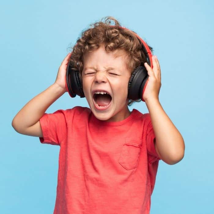 young boy with headphones on and eyes closed