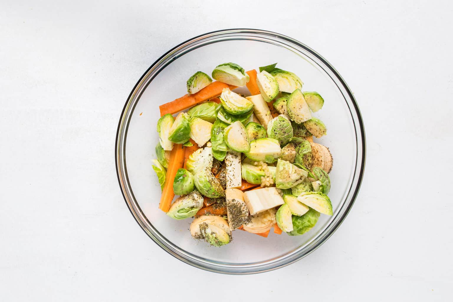 clear bowl with brussel sprouts, carrots and parsnips