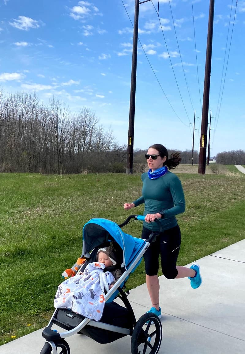 mom running and pushing stroller with baby in it
