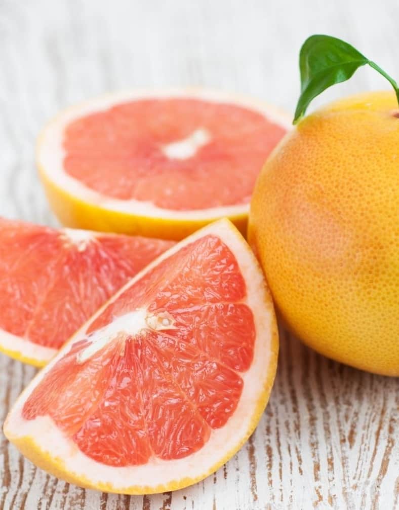 grapefruit next to sliced grapefruit