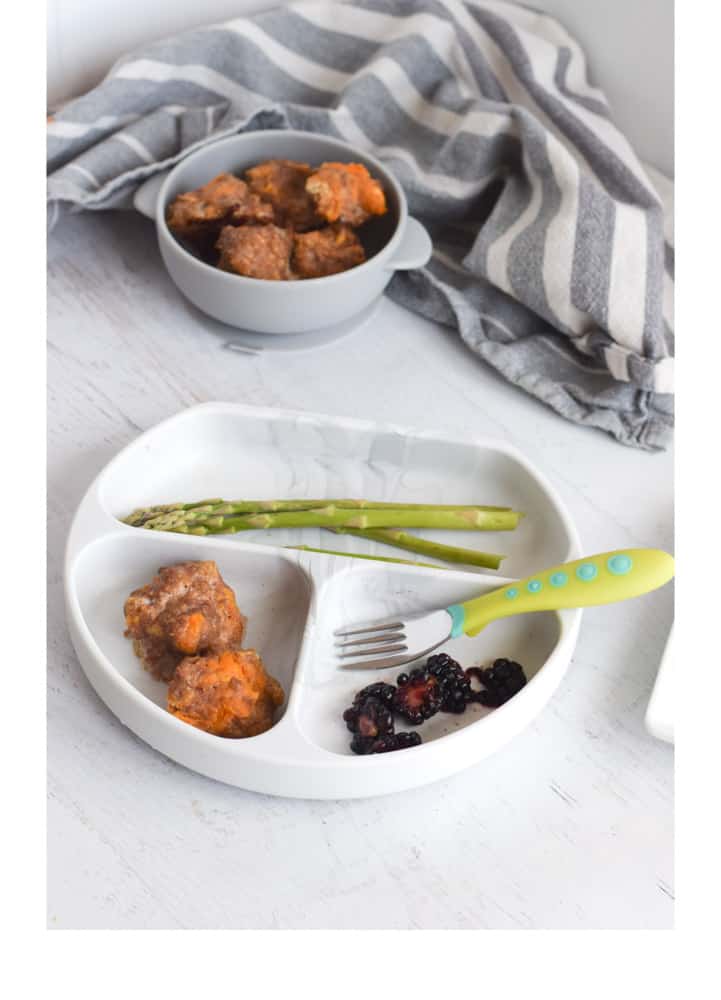 Turkey meatballs with blackberries and asparagus on toddler friendly plate