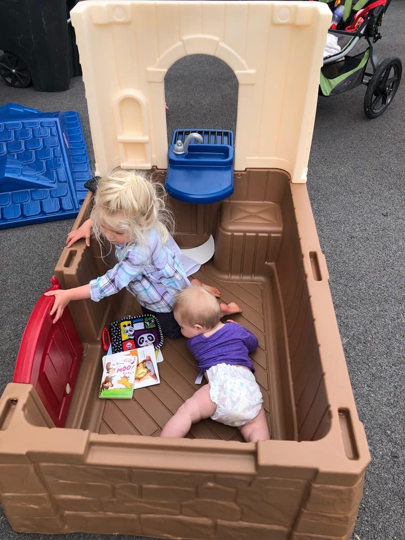 toddler and baby in playhouse