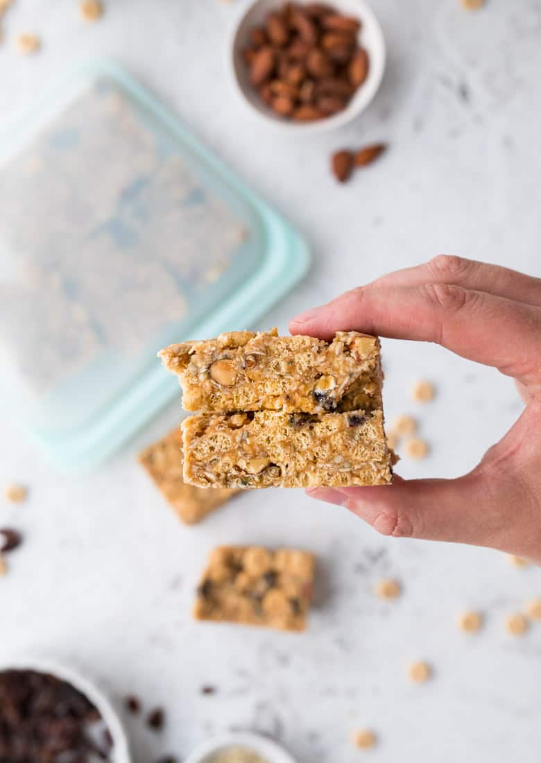 holding healthy cereal bars with peanut butter and cheerios and nuts