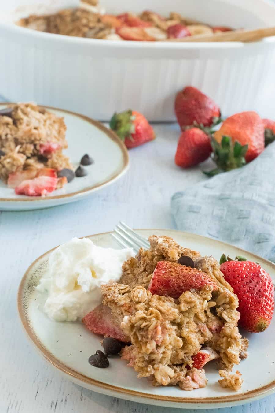 plate of baked oatmeal with strawberries and yogurt