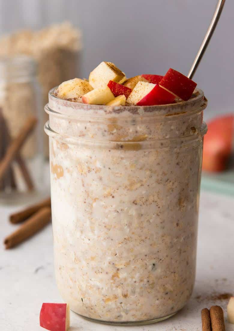 High protein overnight oats recipe topped with diced red apples in mason jar